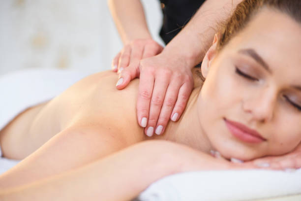 istock Handsome relaxing woman during massage in spa salon. 1207328216