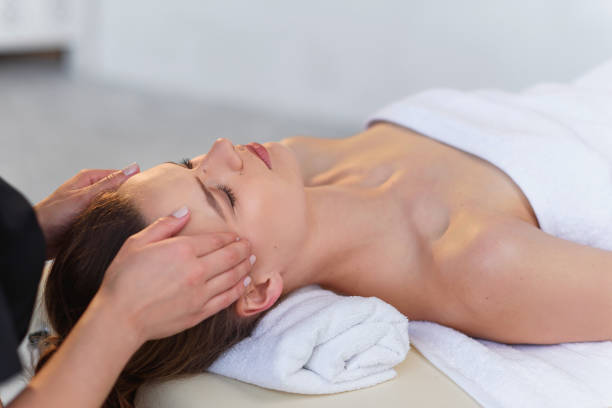istock Young masseur making massage for young female client. 1207328963