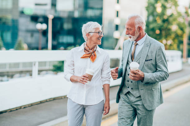 istock Two senior business persons walking outdoors 1207329184