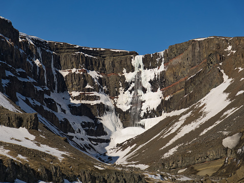 The Hengifoss waterfall in the east of Iceland with some snow