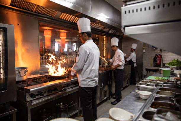 istock Chefs cooking in a professional kitchen of a gourmet restaurant 1207330942