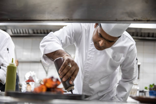 istock Chefs cooking in a professional kitchen of a gourmet restaurant 1207331036