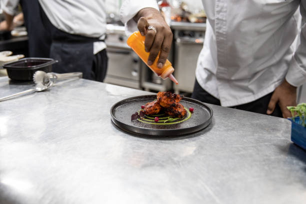 istock Chefs cooking in a professional kitchen of a gourmet restaurant 1207331037
