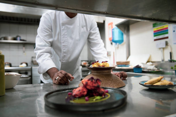 istock Chefs cooking in a professional kitchen of a gourmet restaurant 1207331100