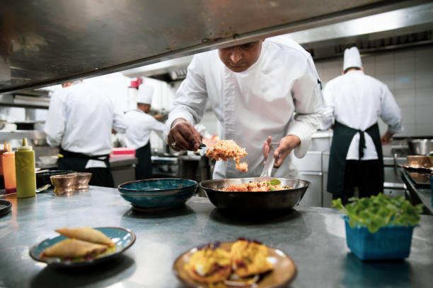 istock Chefs cooking in a professional kitchen of a gourmet restaurant 1207331205