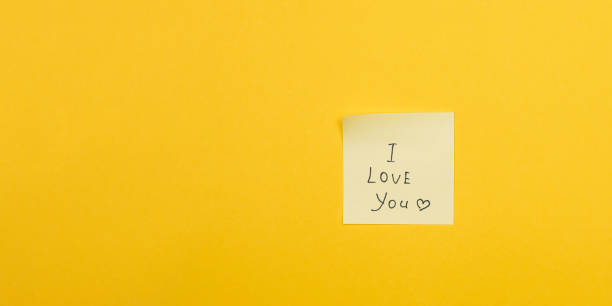 istock yellow sticky note on yellow background and words i love you with copy space 1207333061