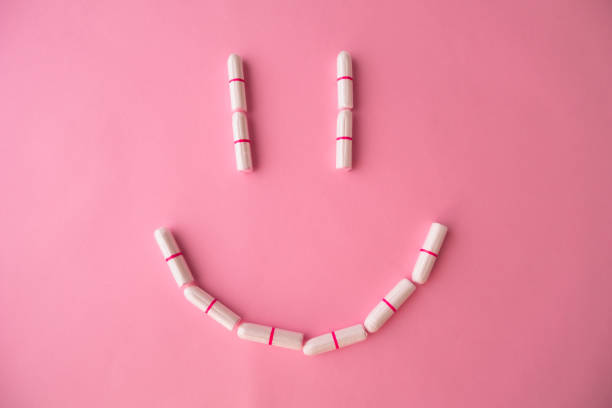 istock Smiley of tampons on a pink background. Flat lay 1207334249