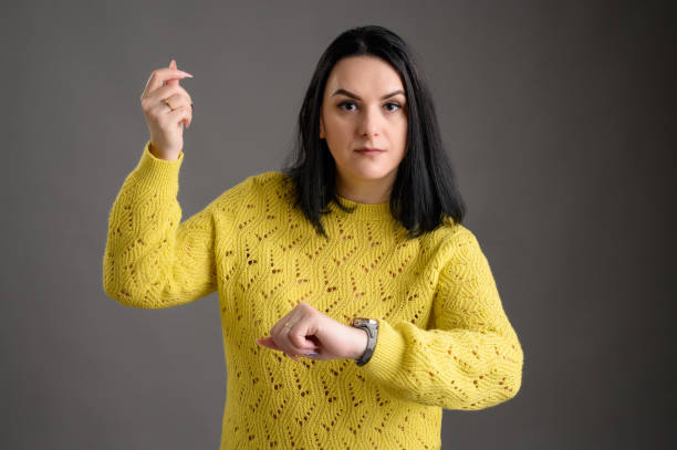 istock Beautiful woman dressed casually showing time is money 1207334298