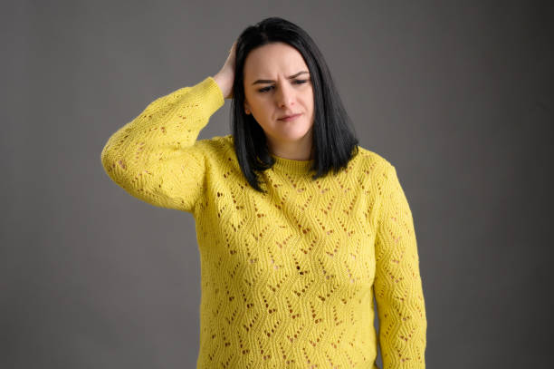 istock Young woman dressed casually has headaches 1207334415