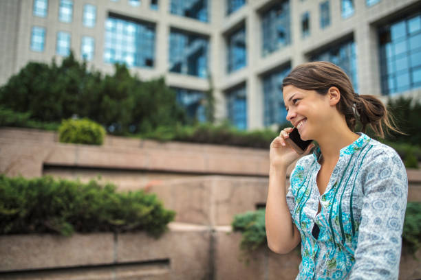 Woman using phone on city street