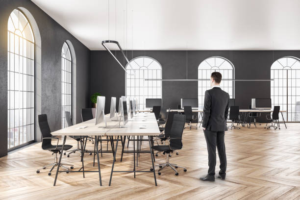 istock Businessman standing in coworking office 1207337672