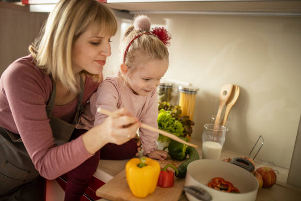 istock Mother and daughter cooking in kitchen 1207339958