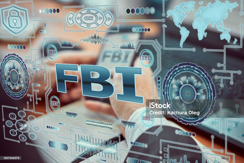 A young agent a futuristic smartphone with the latest holographic technology augmented reality with the inscription "fbi". FBI Stock Photo