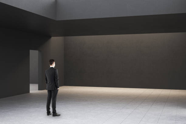 istock Businessman in modern gallery interior 1207340327