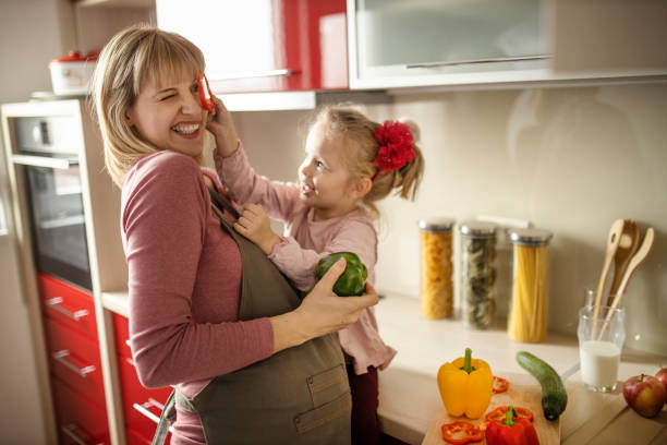 istock Mother and daughter making a face with pepper 1207343373