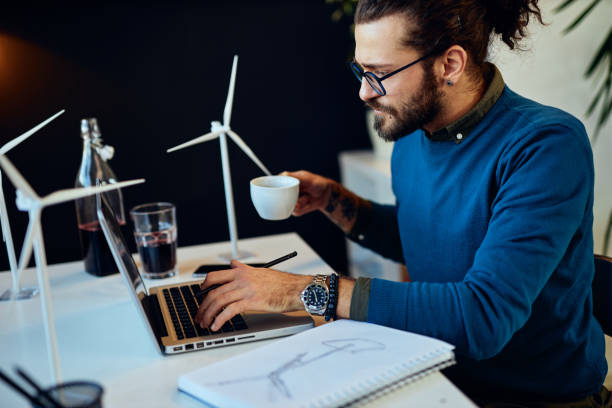 istock Handsome caucasian bearded businessman sitting in his modern office and using laptop for writing report. 1207343941
