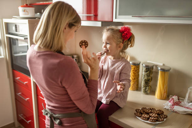 istock Mother, daughter and cookies 1207344942