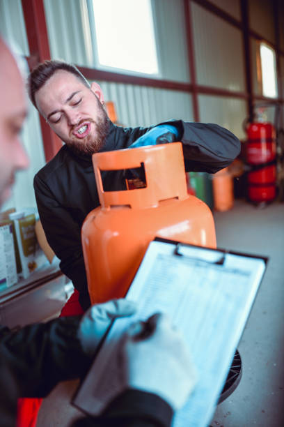 istock Liquified Gas Storage Workers Checking Cylinder Serial Number 1207345128