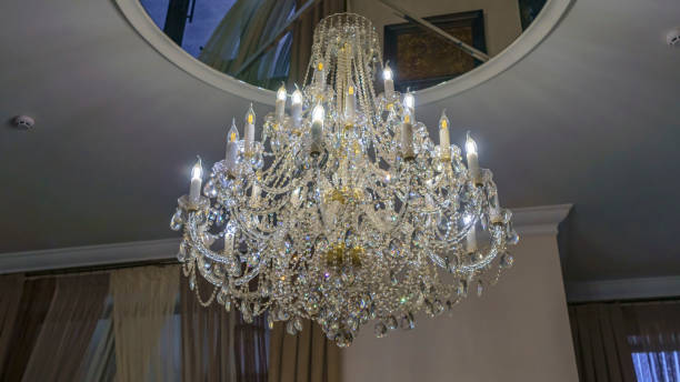 istock Crystal chandelier lighting near the mirror ceiling. 1207345478