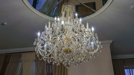 Crystal chandelier lighting near the mirror ceiling.