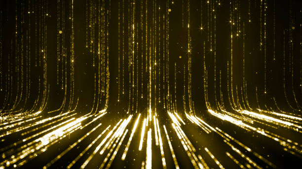 istock Twinkling golden glitter falling on flat surface lit by spotlight 1207346645