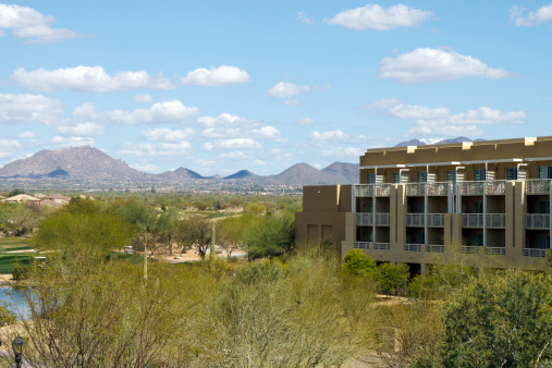 Hotel resort in the Arizona desert with a blue sky and mountains in the background; with copy space for text