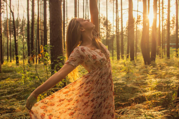 istock Portrait of young beautiful girl in summer dress in forest that dancing 1207347323