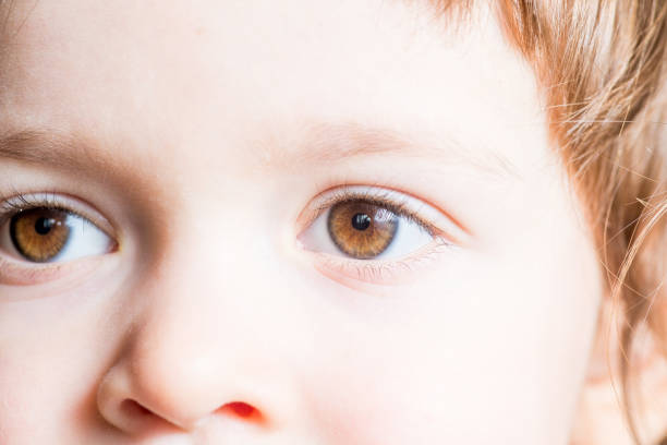 istock baby dark brown eyes close-up. 1207350578