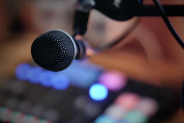 istock Mic in a podcasting or radio studio with podcasting console 1207351064