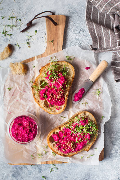 istock Bruschetta with Beetroot hummus decorated with chopped nuts and microgreen. Vegan recipes, plant-based dishes. Green living concept. Organic food. Vegetarian cuisine. Bread with pink dipping sauce 1207351298