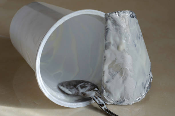 istock A spoon with the remains of yogurt inside a fallen glass. 1207351985