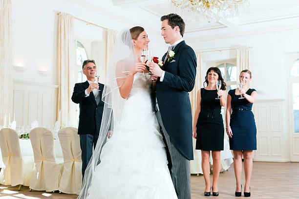Bridal couple clinking glasses