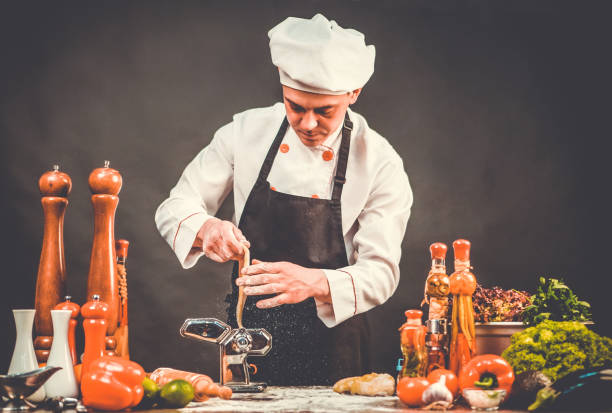 istock Chef cooking handmade pasta at the cuisine table. Manual pasta preparation. 1207353153