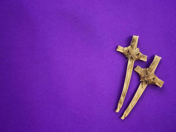 Good Friday, Lent Season and Holy Week concept. Christian crosses made of palm leaves on purple background. the passion of jesus stock pictures, royalty-free photos & images