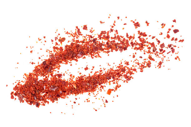 istock Red pepper flakes isolated on a white background 1207354857