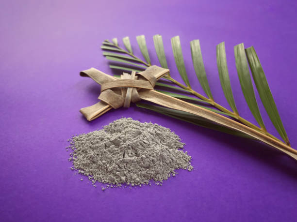 Good Friday, Lent Season, Ash Wednesday and Holy Week concept. A Christian cross, ashes and a palm leaf on purple background. easter sunday photos stock pictures, royalty-free photos & images