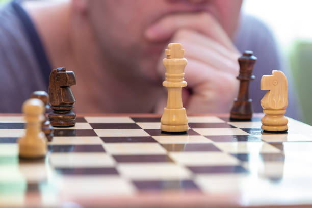 istock A man looks thoughtfully at chess pieces. 1207355429