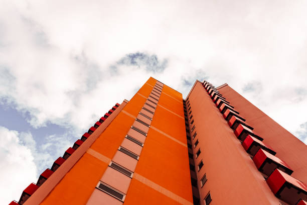 istock a high-rise with small red balkons with a view from below 1207355982