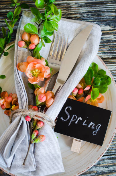 istock Festive table place setting with spring blossoming branch on wooden background. 1207356249