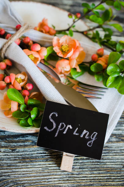 istock Festive table place setting with spring blossoming branch on wooden background. 1207357244