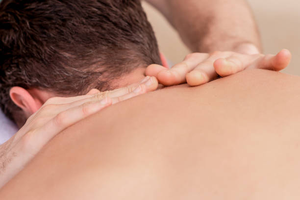istock Young man receiving back massage. 1207358117