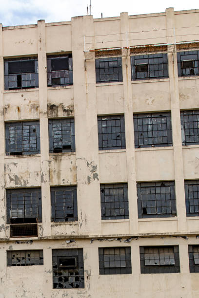 istock The facade of an abandoned building. Broken windows and peeling paint. 1207358213