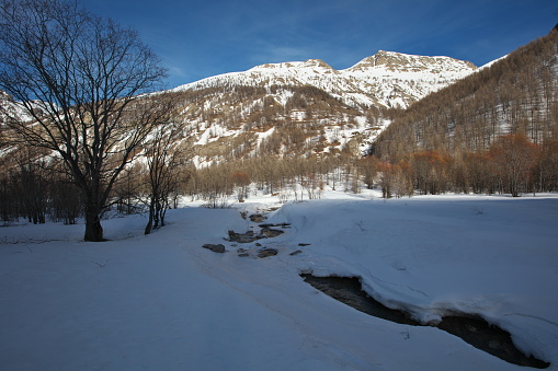 The Bachelard tributary of the Ubaye not far from its source...\nComing down from the Col de la Cayolle towards Bayasse.\nUnder the sun the Tête du Clos des Pastres (2661m) and the Tête du Loup (2721m)