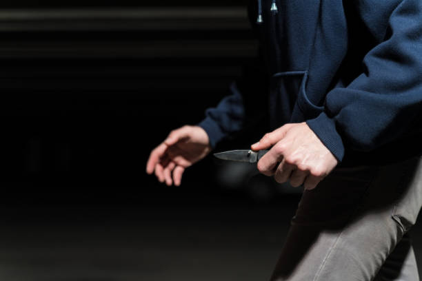 Closeup Of Thief Walking With Weapon