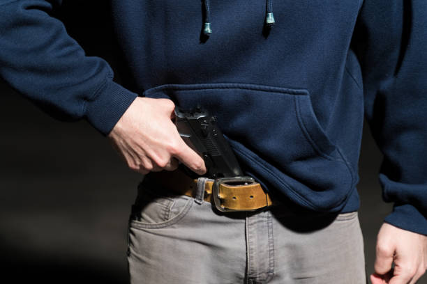 istock Closeup Of Criminal Holding Weapon 1207364255