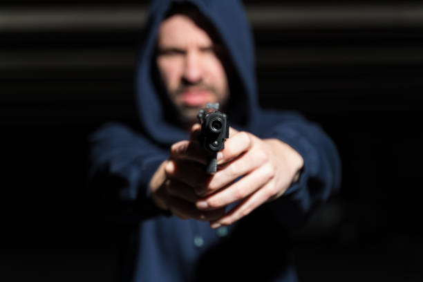 istock Thief With Gun In Dark At Night 1207364267