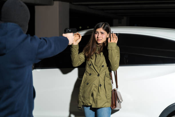 istock Robber Threatening His Victim In Parking Lot 1207364988