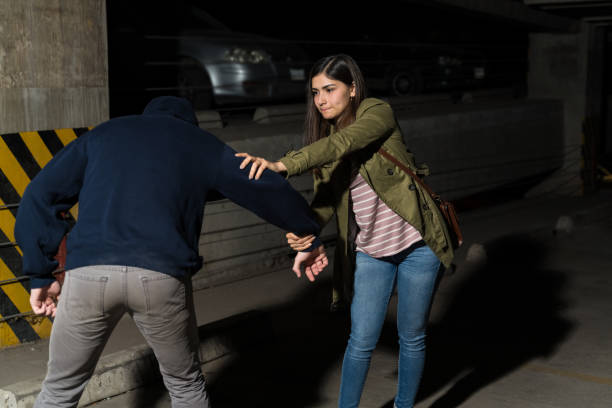 istock Female Victim Fighting Against Criminal 1207365010