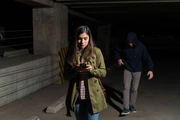 istock Robber Following Unaware Victim In Parking Lot 1207365367