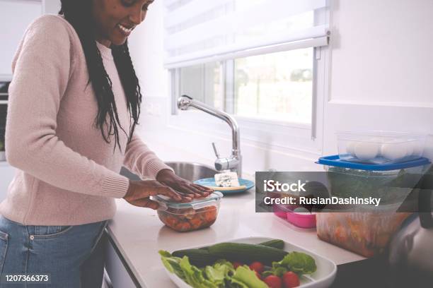 A Woman Keeping Leftovers Stock Photo - Download Image Now - Leftovers, Lunch, Preparing Food
